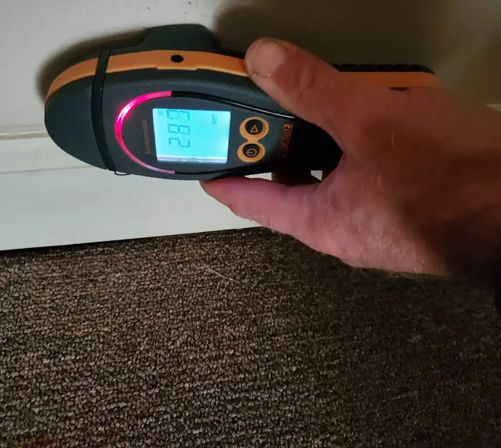 Moisture detection at baseboard during Storm Damage Restoration in Macon-Bibb County